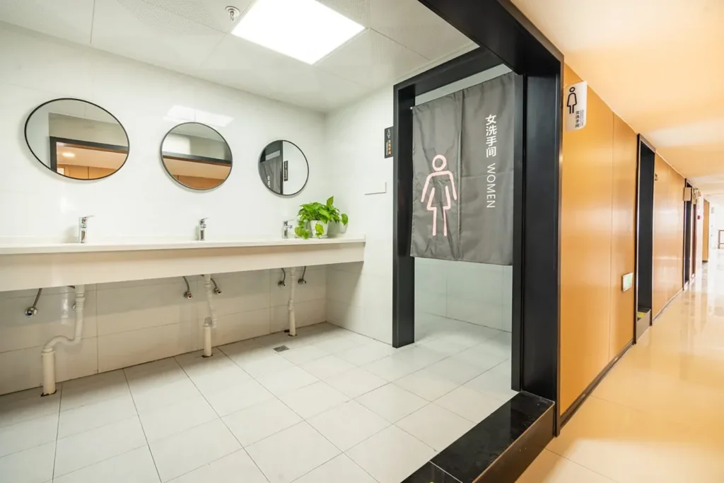 Jushe Hostel washroom and gender-separated zone signage